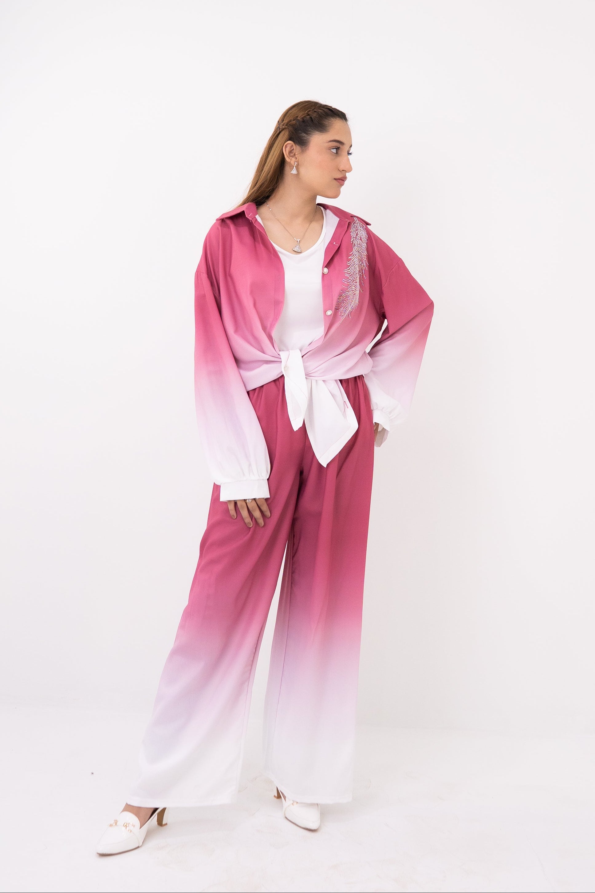 Woman wearing a pink and white gradient outfit on a white background
